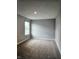 Empty bedroom with neutral walls, carpeted flooring, and natural light from the window at 1932 Downey Ln, Greenfield, IN 46140