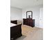 Bedroom with carpet and gray walls complemented by an elegant dark wood dresser with silver hardware and a mirror at 1932 Downey Ln, Greenfield, IN 46140