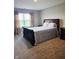 Cozy bedroom with dark furniture, floral curtains, and carpeted floor at 1932 Downey Ln, Greenfield, IN 46140