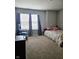 Bright bedroom featuring neutral walls, carpet, and window providing natural light at 1932 Downey Ln, Greenfield, IN 46140