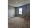 Empty bedroom with neutral walls and carpet with window providing natural light at 1932 Downey Ln, Greenfield, IN 46140