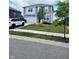 Charming two-story home with a well-manicured lawn, attached garage, and lush, green trees at 1932 Downey Ln, Greenfield, IN 46140