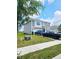 Well-maintained two-story home with an attached garage, grassy front lawn, and sidewalk at 1932 Downey Ln, Greenfield, IN 46140