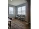 Bright room with wood-look flooring featuring two windows and neutral walls at 1932 Downey Ln, Greenfield, IN 46140