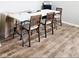 Bright office area featuring a table, chairs, and filing cabinet with wood-look flooring at 1932 Downey Ln, Greenfield, IN 46140