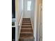 Carpeted staircase with white railing leading to the upper level of the home at 1932 Downey Ln, Greenfield, IN 46140