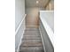 Carpeted staircase with white railing leading to the upper level of the home at 1932 Downey Ln, Greenfield, IN 46140