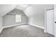 This bedroom features an attic ceiling, a closet, a window, and neutral carpet and paint at 209 Howard Ave, Arcadia, IN 46030