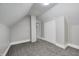 This attic bedroom boasts neutral carpet and paint, and a closet at 209 Howard Ave, Arcadia, IN 46030