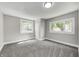 This bedroom boasts large windows and neutral carpet and paint at 209 Howard Ave, Arcadia, IN 46030