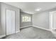 This bedroom boasts a closet, window, and neutral carpet and paint at 209 Howard Ave, Arcadia, IN 46030
