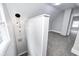 This hallway features neutral paint and carpet, and leads into an attic bedroom at 209 Howard Ave, Arcadia, IN 46030