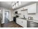 Modern kitchen featuring granite countertops, stainless steel appliances, and sleek white cabinetry at 209 Howard Ave, Arcadia, IN 46030