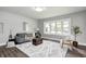 Bright living room boasts new floors, large window, and modern decor with a cozy atmosphere at 209 Howard Ave, Arcadia, IN 46030