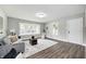 Bright living room boasts new floors, large window, and modern decor with a cozy atmosphere at 209 Howard Ave, Arcadia, IN 46030