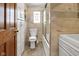 Remodeled bathroom with marble tile, glass shower doors, and built in storage cabinet at 2400 Walnut St, Anderson, IN 46016