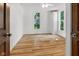 Bright bedroom with hardwood floors, two windows, and a closet at 2400 Walnut St, Anderson, IN 46016