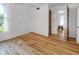 Bright bedroom with hardwood floors, a window, and a door at 2400 Walnut St, Anderson, IN 46016