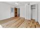 Bright bedroom with hardwood floors, white trim, a closet and a door at 2400 Walnut St, Anderson, IN 46016