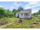 Quaint single story home featuring white siding and a neatly maintained lawn and charming exterior details at 2400 Walnut St, Anderson, IN 46016