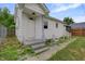 Exterior view of a charming home featuring white siding and a welcoming front entrance at 2400 Walnut St, Anderson, IN 46016