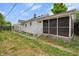 Exterior of home with screened in porch, small shed, and fenced yard at 2400 Walnut St, Anderson, IN 46016