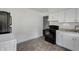 Well-lit kitchen featuring modern appliances, white cabinets, and neutral countertops at 2400 Walnut St, Anderson, IN 46016