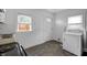 Clean kitchen with natural light and a white washing machine and utility sink at 2400 Walnut St, Anderson, IN 46016