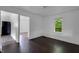 Open living area with dark hardwood floors and bright white walls at 2400 Walnut St, Anderson, IN 46016