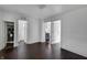 Open living area with dark hardwood floors and bright white walls at 2400 Walnut St, Anderson, IN 46016