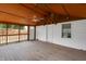 Cozy screened porch featuring wood flooring and ceiling fan, ideal for enjoying the outdoors at 2400 Walnut St, Anderson, IN 46016