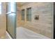 Close up of newly remodeled bathtub and shower with marble tile surround at 2400 Walnut St, Anderson, IN 46016
