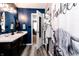 Bathroom showcasing a vanity, a modern light fixture, and a blue accent wall at 2550 Cedarmill Dr, Franklin, IN 46131