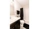 Modern bathroom featuring a black shower curtain, white tile surround, and a dark vanity at 2550 Cedarmill Dr, Franklin, IN 46131
