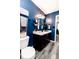 Charming bathroom with a vanity, blue accent wall, and modern light fixture at 2550 Cedarmill Dr, Franklin, IN 46131