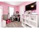 Pink bedroom with a play kitchen, television, window with curtains and shelving unit at 2550 Cedarmill Dr, Franklin, IN 46131