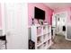 Pink bedroom featuring a large shelving unit, television and views of the hallway at 2550 Cedarmill Dr, Franklin, IN 46131