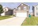Two-story home featuring a two-car garage and a concrete driveway at 2550 Cedarmill Dr, Franklin, IN 46131