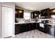 This home offers a stylish kitchen with dark cabinets, white countertops, and modern appliances at 2550 Cedarmill Dr, Franklin, IN 46131