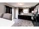 This bright kitchen features dark cabinetry, stainless appliances, and ample countertop space for cooking at 2550 Cedarmill Dr, Franklin, IN 46131