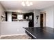 View of the ping pong table and kitchen area highlights the home's layout, ideal for modern living at 2550 Cedarmill Dr, Franklin, IN 46131