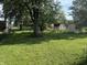 Expansive green backyard features storage sheds and mature trees at 3309 Wedgewood Dr, Indianapolis, IN 46227