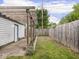 View of garage, backyard, and patio featuring green grass, wooden fence, and pergola at 3936 Graceland Ave, Indianapolis, IN 46208