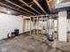 Unfinished basement featuring exposed utilities, concrete floor, and cinder block foundation at 3936 Graceland Ave, Indianapolis, IN 46208