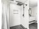 Elegant bathroom featuring a walk-in shower with white subway tile and dark fixtures at 3936 Graceland Ave, Indianapolis, IN 46208