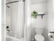Bathroom with a shower-tub, toilet, and dark fixtures at 3936 Graceland Ave, Indianapolis, IN 46208