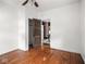 Bedroom with open closet, hardwood floors and view to dining room at 3936 Graceland Ave, Indianapolis, IN 46208