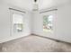 Bright room featuring carpet floors and two windows at 3936 Graceland Ave, Indianapolis, IN 46208