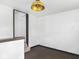 Neutral room with short set of stairs, views to the upstairs, and updated lighting at 3936 Graceland Ave, Indianapolis, IN 46208