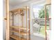 Open closet with wooden shelving beside a large window at 3936 Graceland Ave, Indianapolis, IN 46208